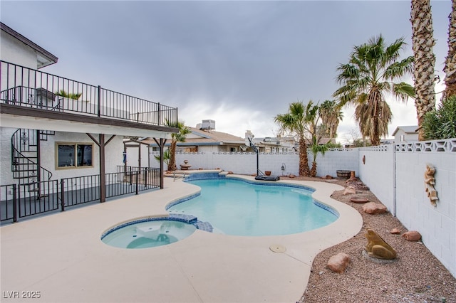 view of pool with an in ground hot tub and a patio area