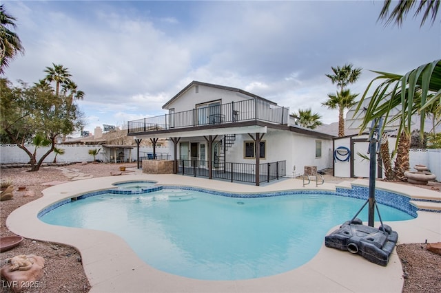 view of swimming pool with an in ground hot tub and a patio area