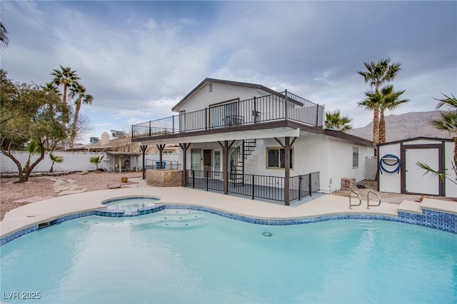 view of pool featuring an in ground hot tub, a storage unit, and a patio