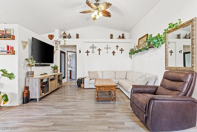 living room with vaulted ceiling, ceiling fan, and light hardwood / wood-style floors