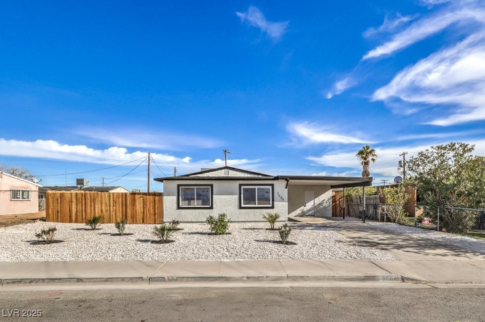 single story home featuring a carport