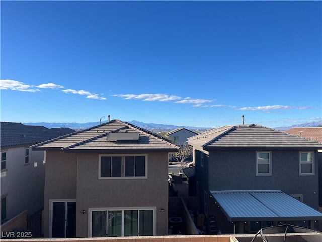 back of house featuring a mountain view