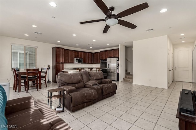 living room with light tile patterned floors and ceiling fan