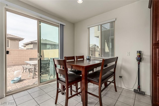 dining space with light tile patterned floors and a wealth of natural light