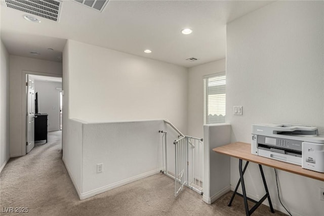 hall with light colored carpet