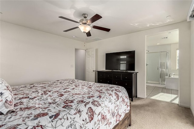 carpeted bedroom featuring ceiling fan and ensuite bathroom