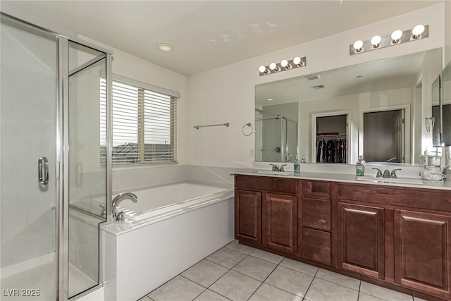 bathroom featuring plus walk in shower, tile patterned floors, and vanity