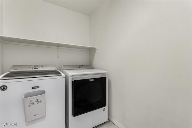 clothes washing area with separate washer and dryer