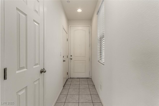 hall featuring light tile patterned flooring