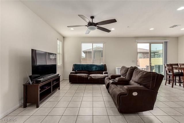 living room featuring a wealth of natural light, ceiling fan, and light tile patterned flooring