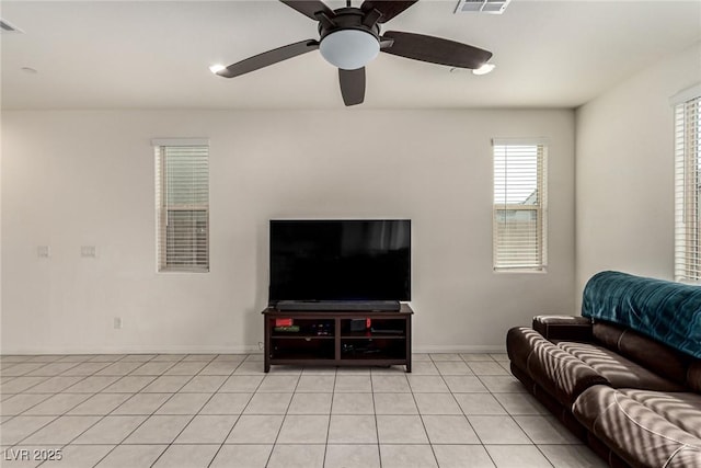 tiled living room with ceiling fan