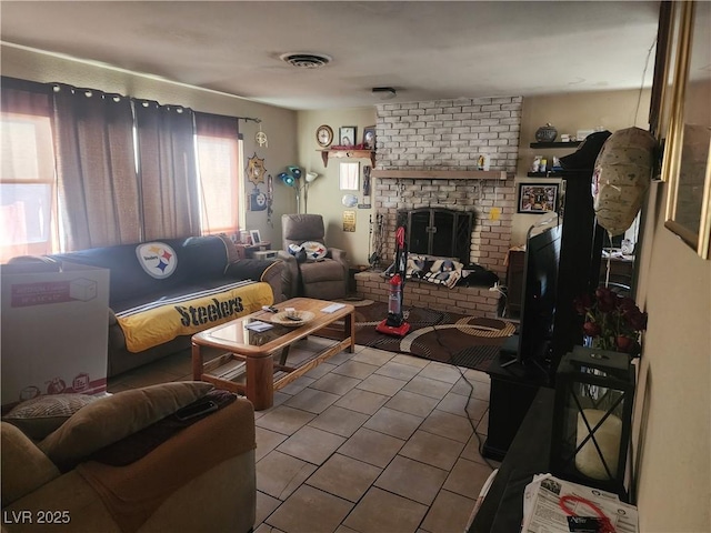 living room featuring a brick fireplace