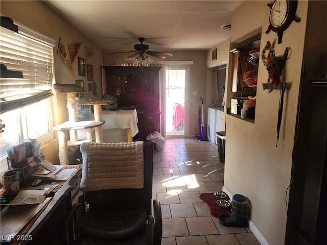 kitchen featuring ceiling fan, washer and dryer, and light tile patterned floors