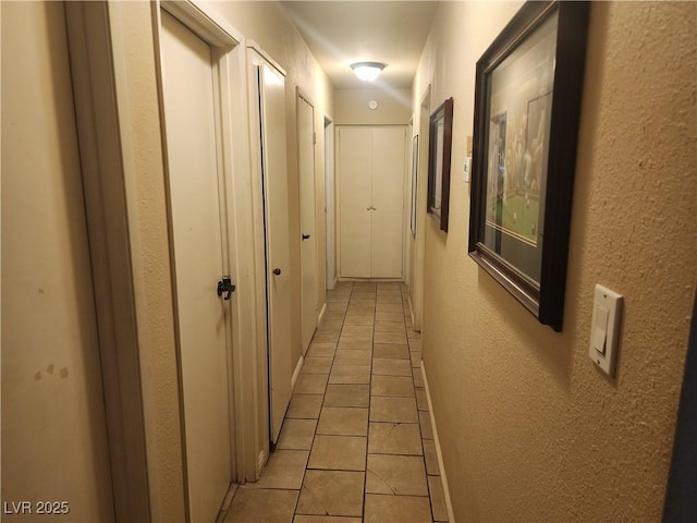 hall with light tile patterned flooring