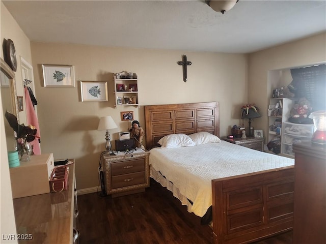 bedroom with dark hardwood / wood-style flooring