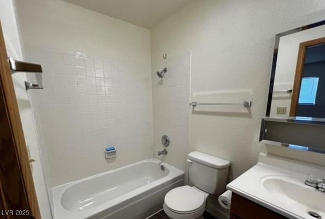 full bathroom featuring vanity, toilet, and tiled shower / bath