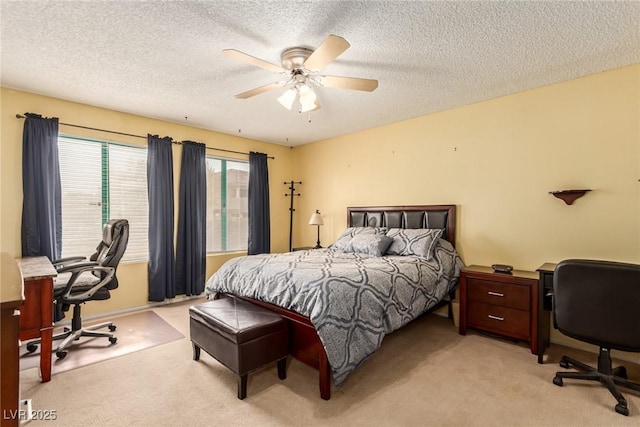 bedroom with light carpet, a textured ceiling, and ceiling fan