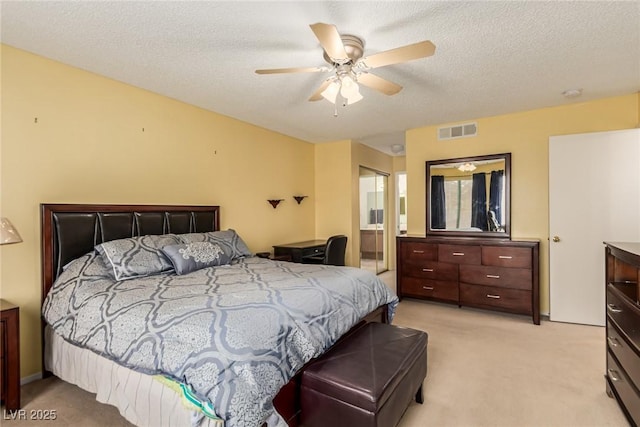 carpeted bedroom featuring connected bathroom, a textured ceiling, and ceiling fan