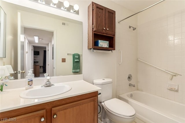 full bathroom with vanity, tiled shower / bath combo, and toilet