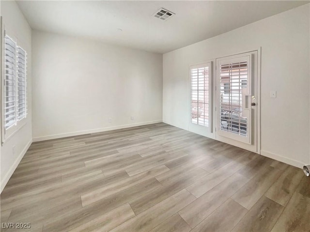 unfurnished room with light hardwood / wood-style flooring