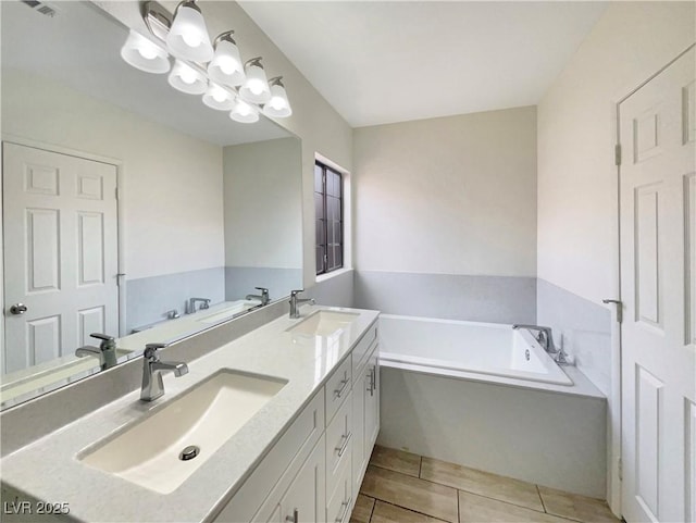 bathroom with vanity, a tub to relax in, and an inviting chandelier