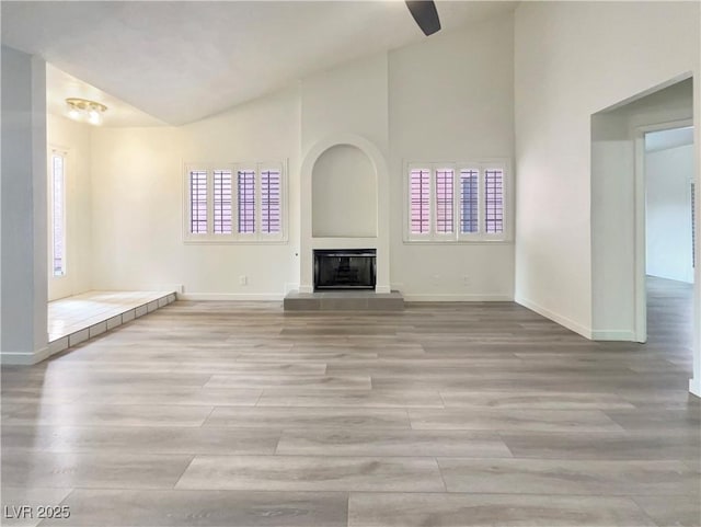 unfurnished living room with a fireplace and light wood-type flooring