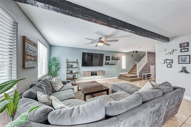 tiled living room featuring ceiling fan and beamed ceiling