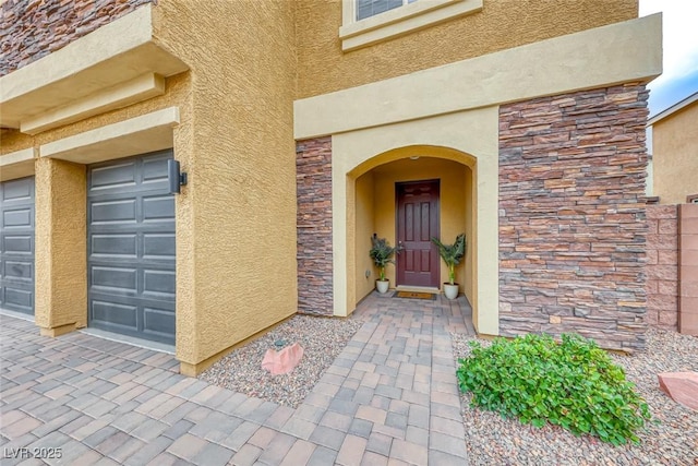 doorway to property with a garage