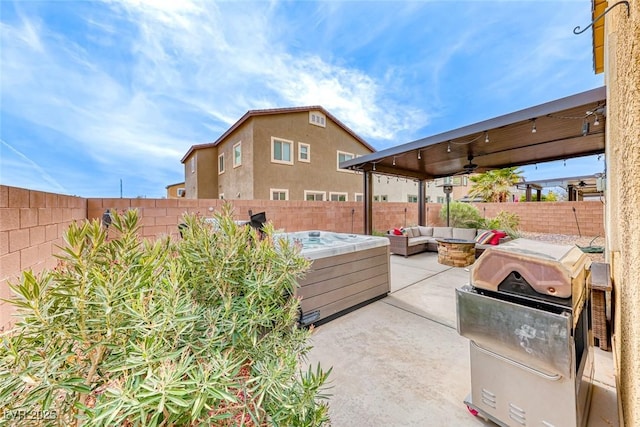 view of patio featuring ceiling fan, an outdoor hangout area, and a hot tub