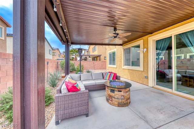 view of patio with an outdoor living space with a fire pit and ceiling fan