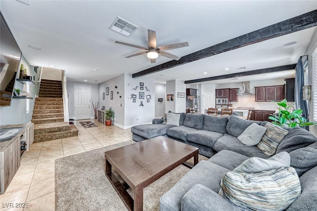 living room with ceiling fan, beamed ceiling, and light tile patterned flooring