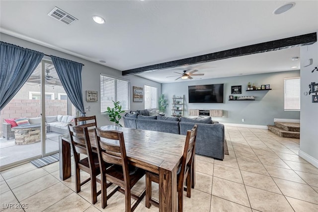 dining area with beamed ceiling, a healthy amount of sunlight, and light tile patterned flooring