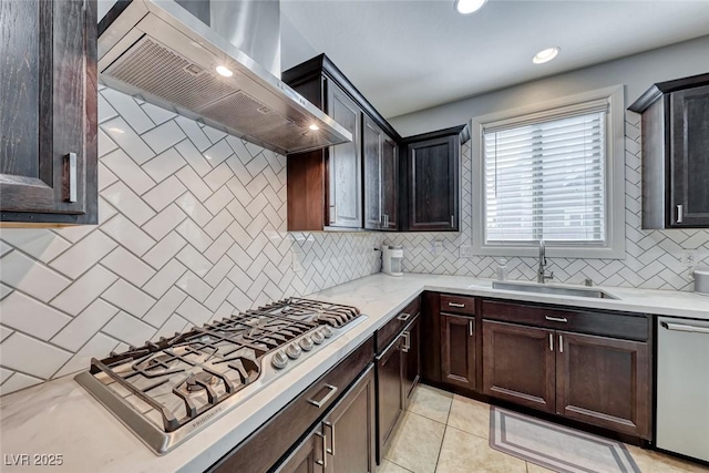 kitchen featuring extractor fan, sink, decorative backsplash, light tile patterned floors, and stainless steel appliances