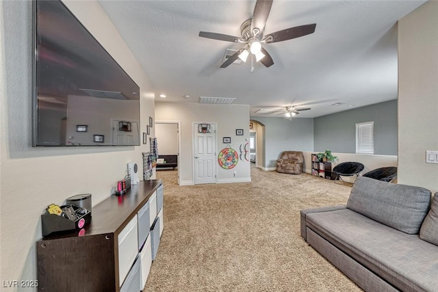 carpeted living room featuring ceiling fan