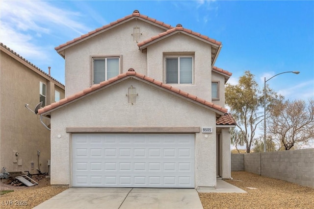 mediterranean / spanish-style house with a garage