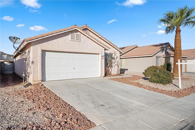 ranch-style house with an attached garage, fence, concrete driveway, a tiled roof, and stucco siding