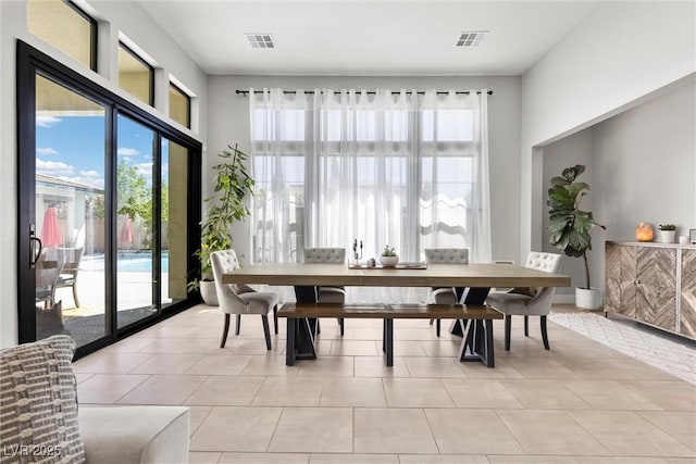 dining space featuring a healthy amount of sunlight and light tile patterned flooring