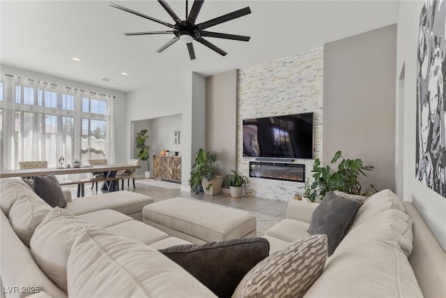 living room featuring a stone fireplace