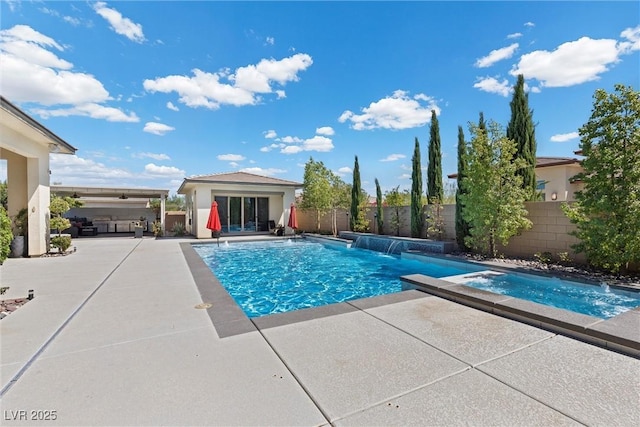 view of swimming pool with a patio area, pool water feature, and an in ground hot tub