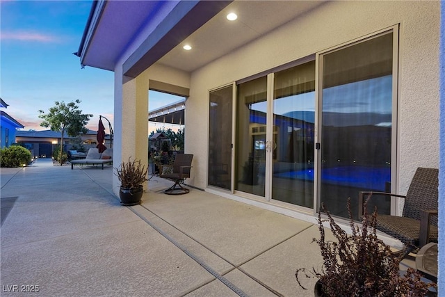 view of patio terrace at dusk