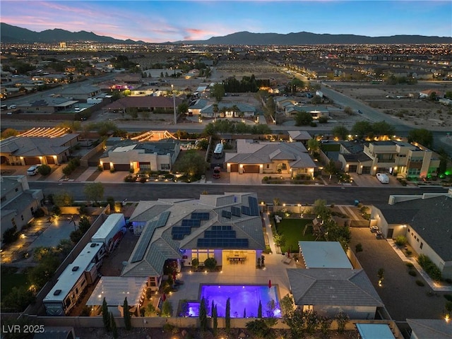 aerial view at dusk featuring a mountain view