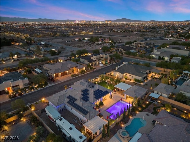 aerial view at dusk featuring a mountain view