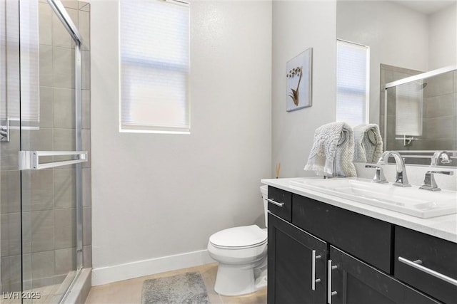 bathroom featuring tile patterned flooring, vanity, an enclosed shower, and toilet