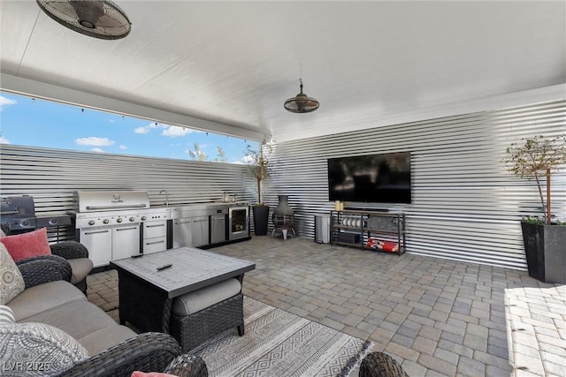 view of patio featuring an outdoor living space, area for grilling, and ceiling fan