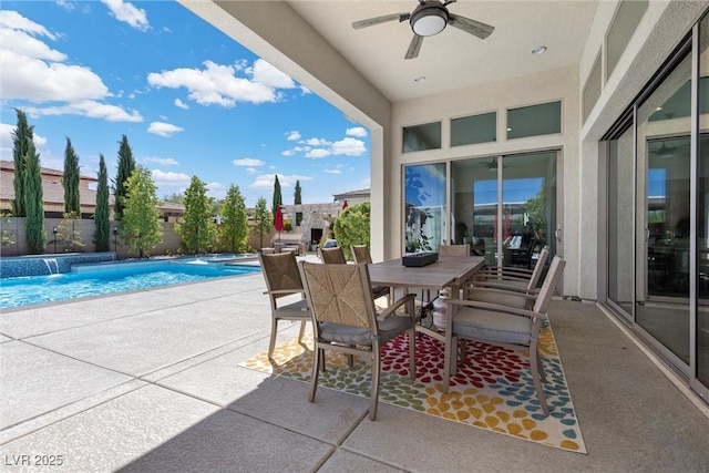 view of patio / terrace featuring a fenced in pool, pool water feature, and ceiling fan