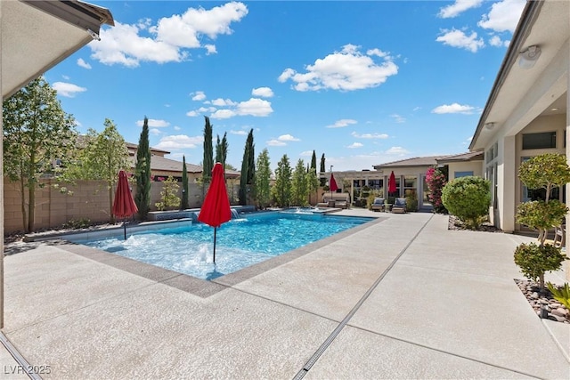 view of pool with a patio area and pool water feature