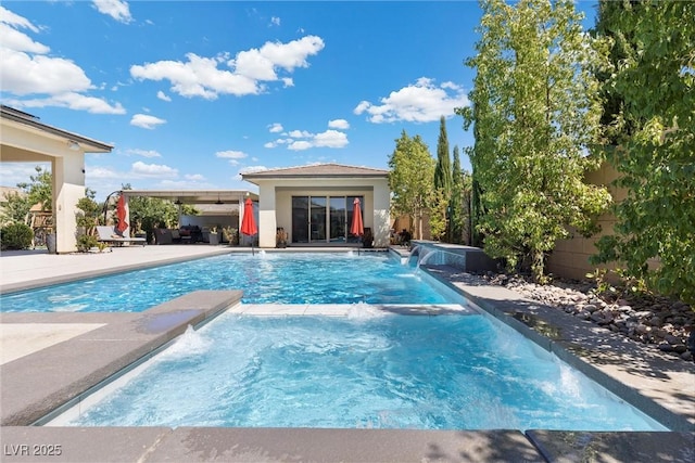 view of swimming pool with pool water feature, an outdoor structure, and a patio