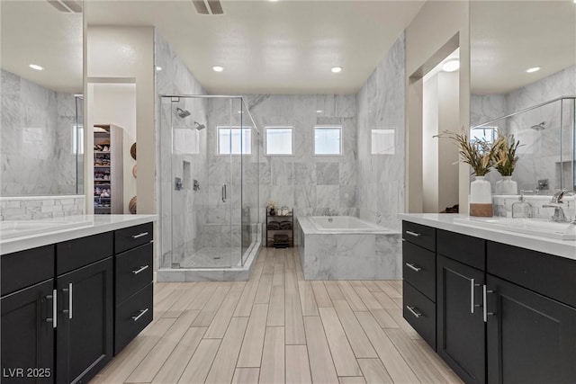 bathroom featuring vanity, separate shower and tub, and tile walls