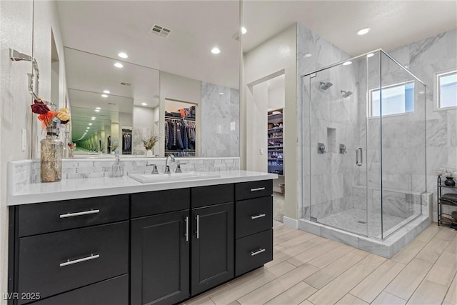 bathroom with vanity and an enclosed shower