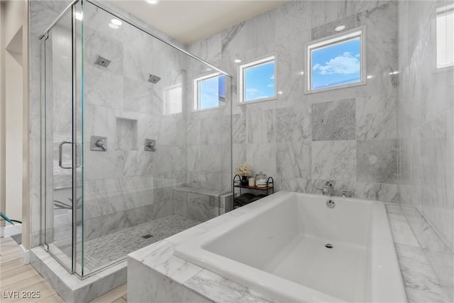 bathroom with shower with separate bathtub